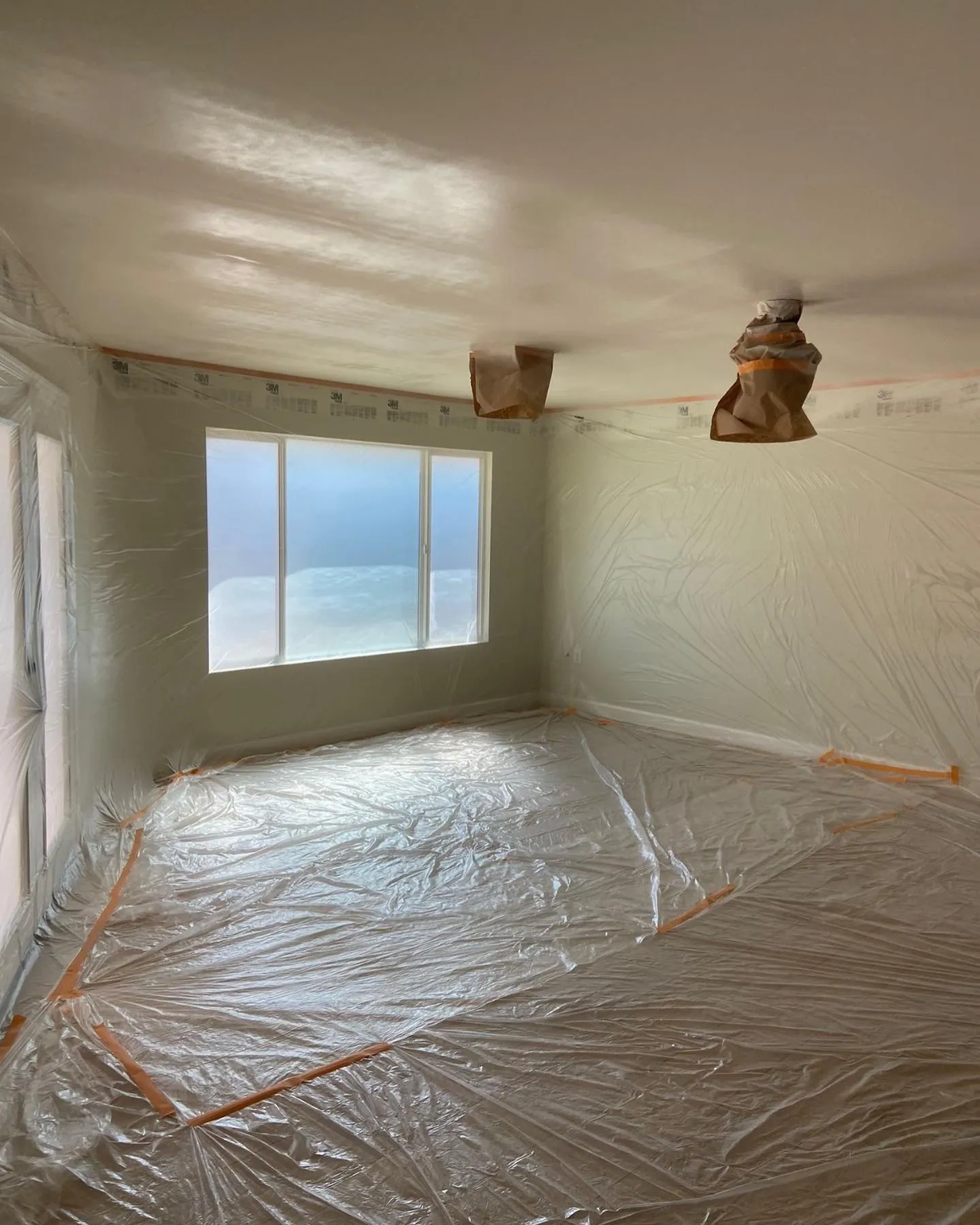Bedroom prepped with floors and windows masked